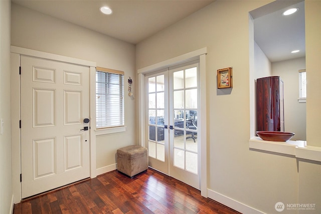 foyer featuring baseboards, dark wood-type flooring, recessed lighting, and french doors