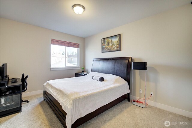 carpeted bedroom featuring baseboards