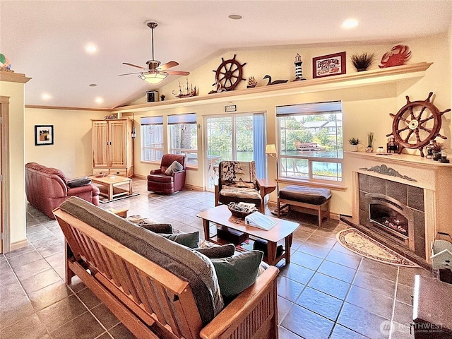 tiled living area featuring lofted ceiling, ceiling fan, a tiled fireplace, recessed lighting, and baseboards