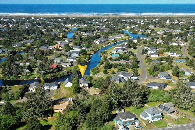 view of property location with a large body of water and nearby suburban area