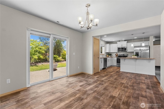 3612 64th St E, Tacoma, WA 98443 - kitchen with appliances with stainless steel finishes, dark wood-style flooring, a chandelier, white cabinets, and recessed lighting
