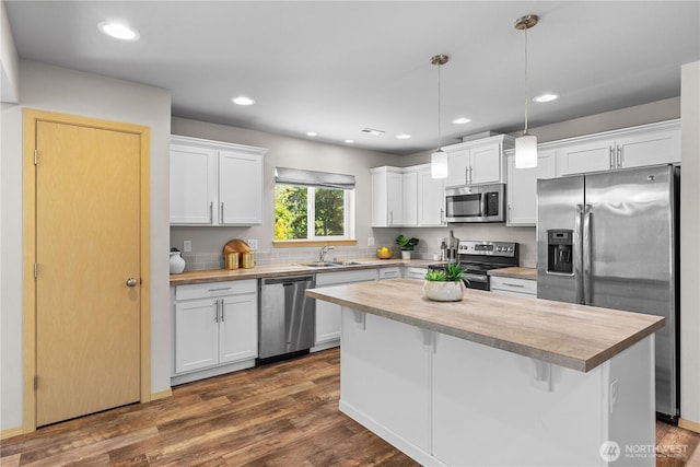 3612 64th St E, Tacoma, WA 98443 - kitchen featuring stainless steel appliances, white cabinetry, a center island, decorative light fixtures, and recessed lighting