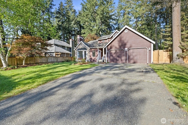 view of front of house with driveway, a garage, and a chimney