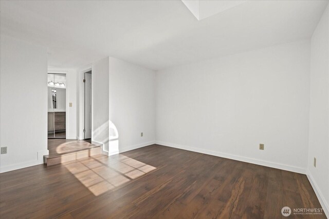 unfurnished room featuring wood finished floors and baseboards