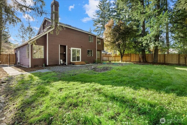 back of property featuring entry steps and a chimney
