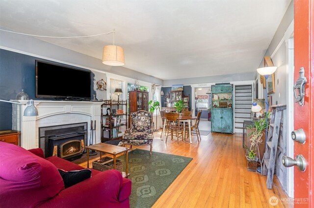 living area with hardwood / wood-style floors and a fireplace