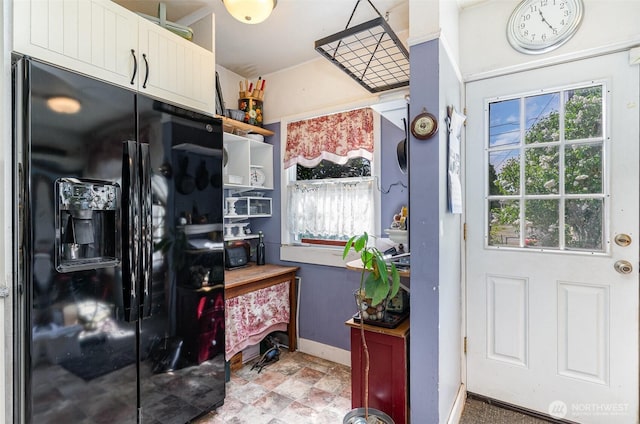 entryway featuring plenty of natural light and baseboards