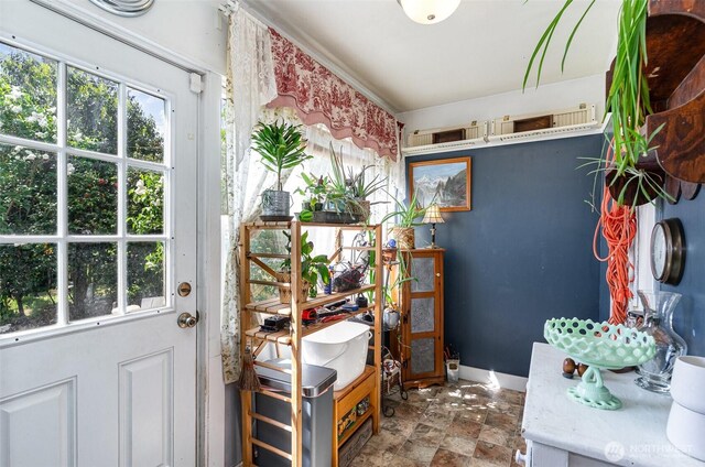 doorway to outside featuring stone finish floors