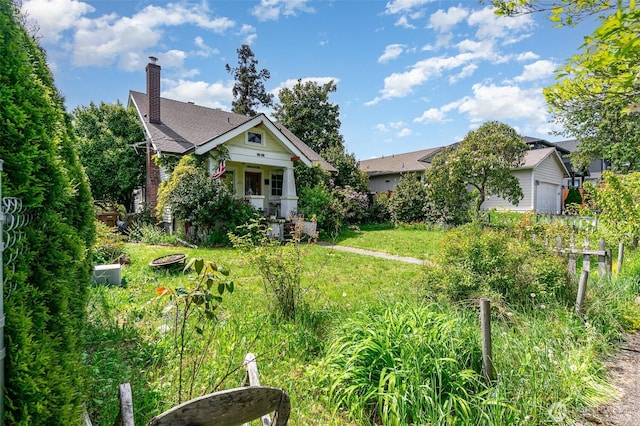 view of front of property with a chimney and a front lawn