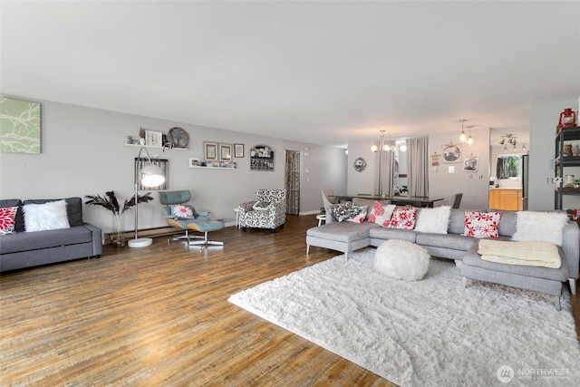 living area featuring wood finished floors and a chandelier