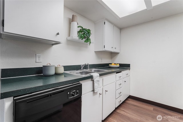 kitchen with dishwasher, a sink, dark countertops, white cabinets, and wood finished floors