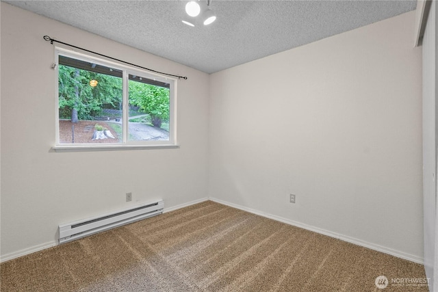 empty room with a baseboard heating unit, carpet flooring, a textured ceiling, and baseboards