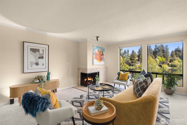 carpeted living area featuring baseboards, ornamental molding, and a warm lit fireplace