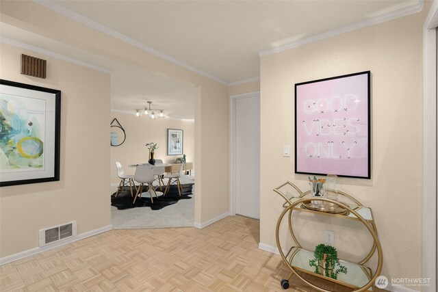 corridor with baseboards, a chandelier, and ornamental molding