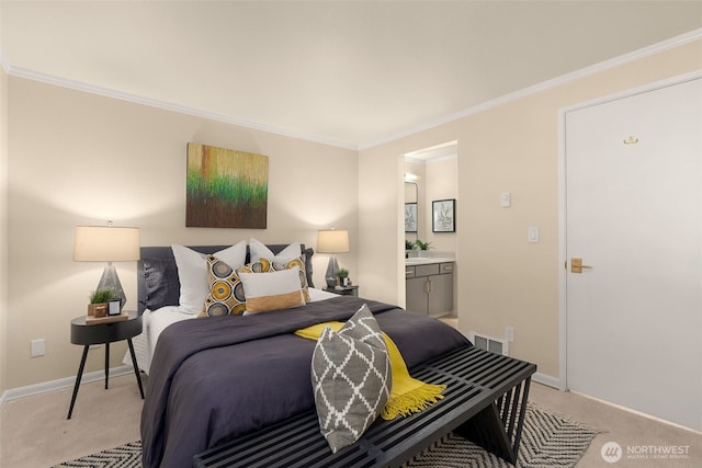 bedroom with light colored carpet, ornamental molding, baseboards, and connected bathroom