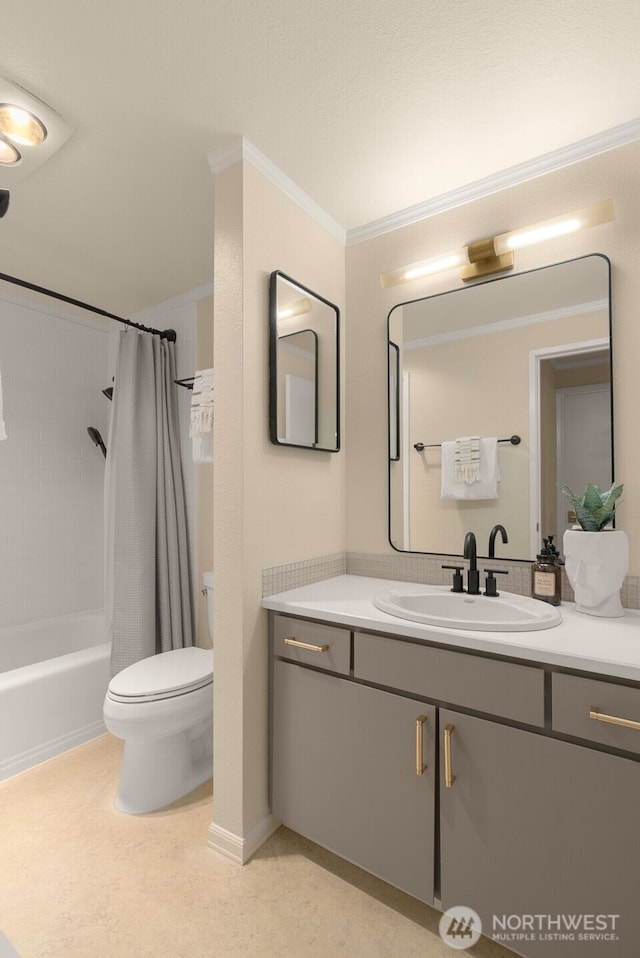 full bathroom featuring toilet, vanity, shower / bath combo with shower curtain, and crown molding