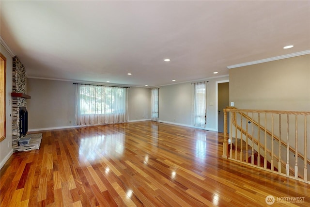 2022 Scarpelli Dr, Walla Walla, WA 99362 - unfurnished living room featuring crown molding, light wood-style flooring, baseboards, recessed lighting, and a fireplace