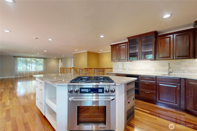2022 Scarpelli Dr, Walla Walla, WA 99362 - kitchen with stainless steel stove, light wood-style floors, tasteful backsplash, and recessed lighting