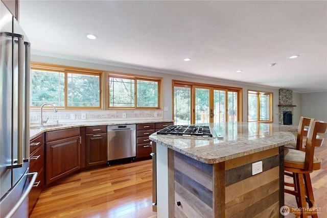 2022 Scarpelli Dr, Walla Walla, WA 99362 - kitchen featuring stainless steel appliances, light wood finished floors, a kitchen island, recessed lighting, and decorative backsplash