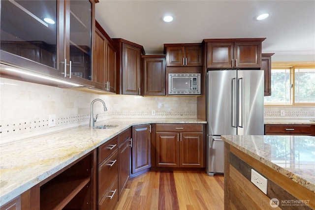 2022 Scarpelli Dr, Walla Walla, WA 99362 - kitchen featuring appliances with stainless steel finishes, a sink, light wood finished floors, light stone counters, and recessed lighting