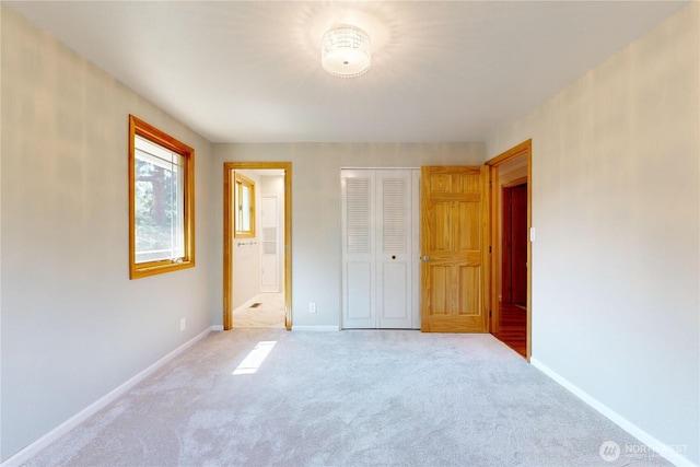 2022 Scarpelli Dr, Walla Walla, WA 99362 - unfurnished bedroom featuring light colored carpet, baseboards, a closet, and connected bathroom