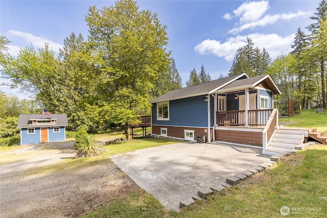 22421 SE 331st St, Auburn, WA 98092 - view of front of property with an outdoor structure, a front lawn, and a wooden deck