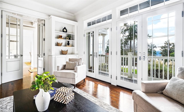 doorway to outside featuring crown molding, a wealth of natural light, french doors, and built in features