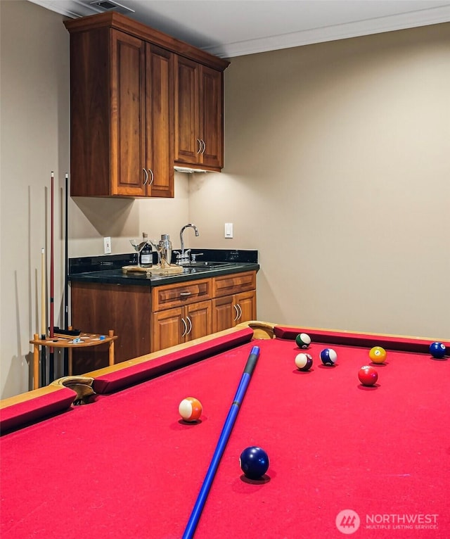recreation room featuring billiards, crown molding, and a sink