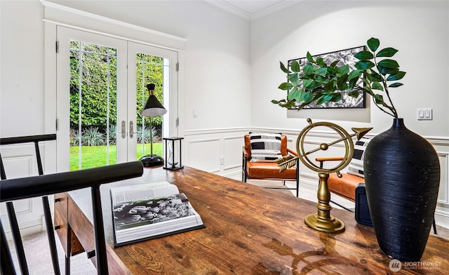 sitting room featuring ornamental molding, french doors, and wainscoting