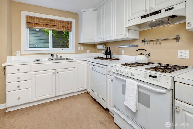 1109 30th Ave, Seattle, WA 98122 - kitchen with white appliances, under cabinet range hood, a sink, light carpet, and white cabinetry