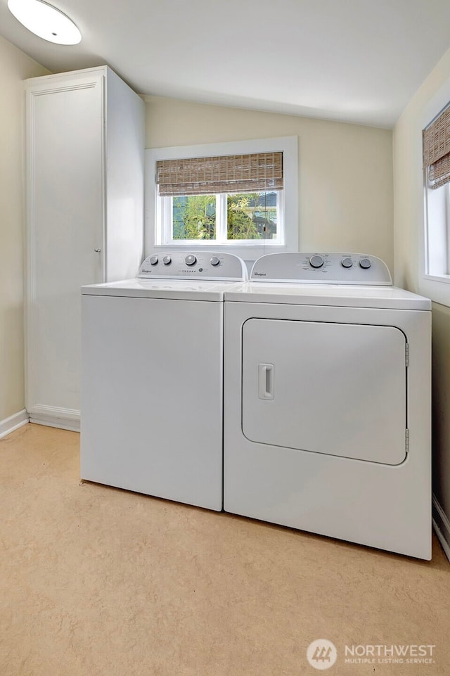 1109 30th Ave, Seattle, WA 98122 - clothes washing area with washing machine and clothes dryer, healthy amount of natural light, and light colored carpet