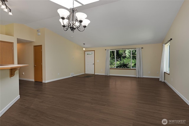 unfurnished living room featuring lofted ceiling, a chandelier, dark wood-style floors, and baseboards