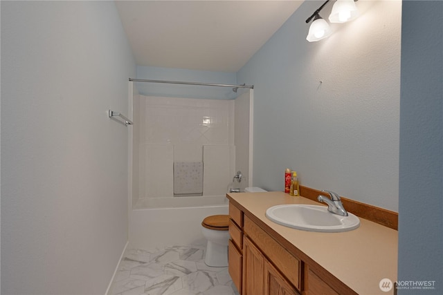 full bathroom with marble finish floors, toilet, vanity, and shower / bathtub combination