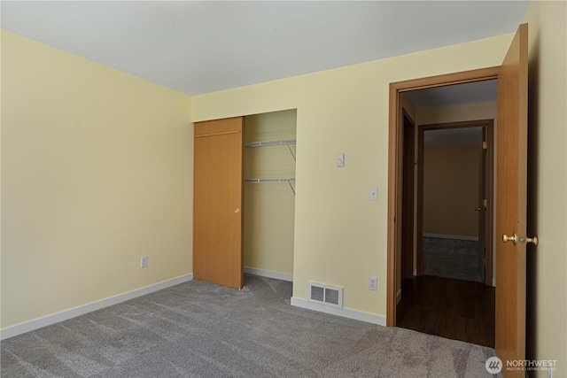 unfurnished bedroom with a closet, carpet flooring, and baseboards