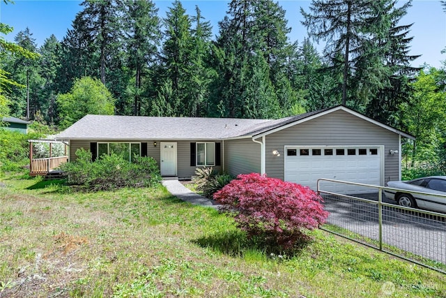ranch-style home with a garage and driveway