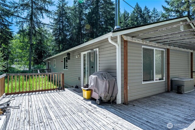 wooden terrace with a grill