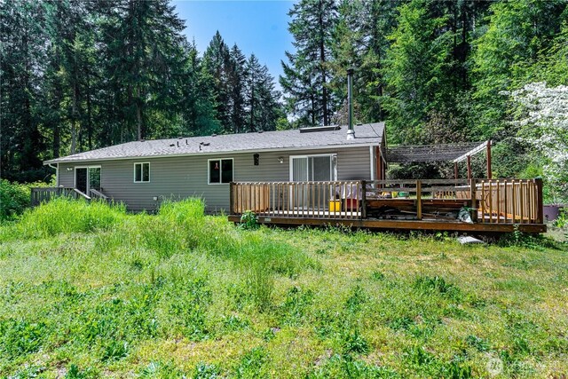 rear view of property featuring a wooden deck