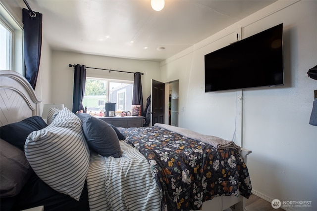 bedroom featuring wood finished floors and baseboards