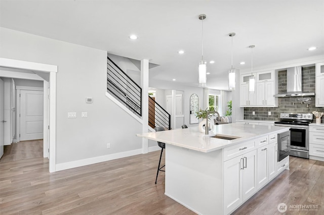 5010 NW Dr, Bellingham, WA 98226 - kitchen with wall chimney exhaust hood, stainless steel electric stove, a sink, white cabinets, and recessed lighting