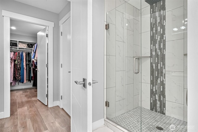 5010 NW Dr, Bellingham, WA 98226 - full bathroom with a stall shower, a spacious closet, wood finished floors, and baseboards