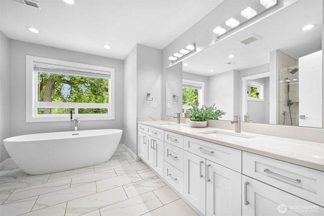 5010 NW Dr, Bellingham, WA 98226 - bathroom with marble look tiles, a shower stall, double vanity, baseboards, and a soaking tub