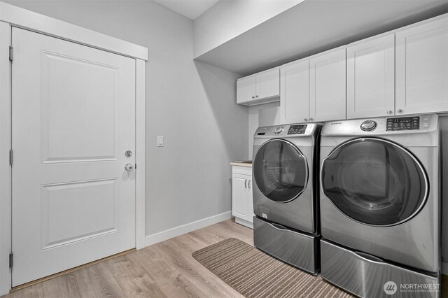 5010 NW Dr, Bellingham, WA 98226 - laundry area featuring cabinet space, washer and dryer, light wood finished floors, and baseboards