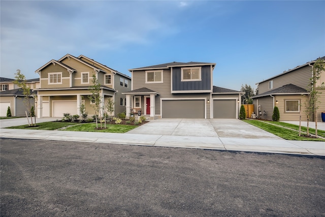 view of front of home with concrete driveway, board and batten siding, and an attached garage