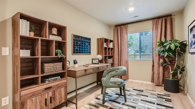 office with visible vents, light wood-style flooring, and baseboards