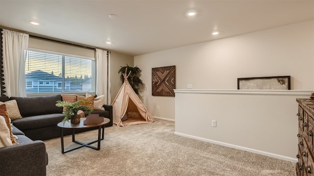living room featuring light carpet, baseboards, and recessed lighting