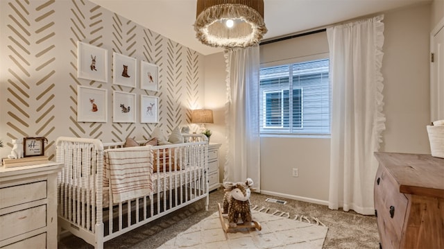 carpeted bedroom with a crib, baseboards, and visible vents