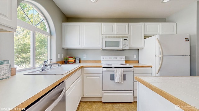 12331 NE 101st Ln, Kirkland, WA 98033 - kitchen featuring white appliances, healthy amount of natural light, a sink, white cabinets, and recessed lighting