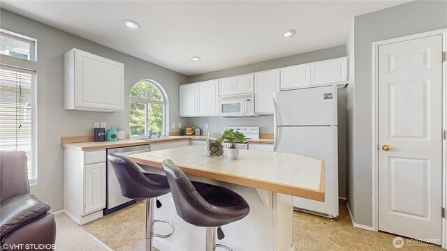 12331 NE 101st Ln, Kirkland, WA 98033 - kitchen featuring white appliances, white cabinetry, tile counters, a sink, and recessed lighting