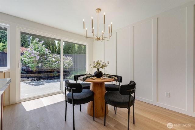 dining space with a chandelier and light wood-type flooring