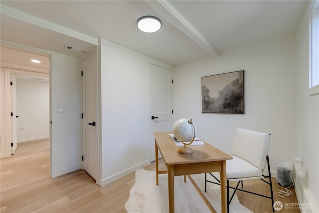 office area with light wood-style flooring, baseboards, and beam ceiling